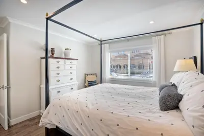 a bedroom with a large bed and a window at 90 Walk Score, Steps to Beach, Dining in Carlsbad