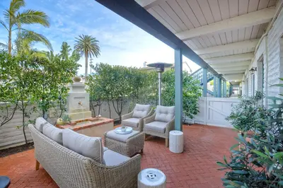 a patio with wicker chairs and a fountain at 90 Walk Score, Steps to Beach, Dining in Carlsbad