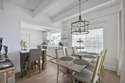 a kitchen and dining room with a table and chairs at Juniper Beach Entire Home - Sleeps 18 - Oceanfront in Carlsbad
