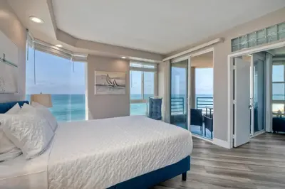 a bedroom with a bed and a view of the ocean at 3BR Oceanview, Gated Community & Parking, Elevator in Oceanside