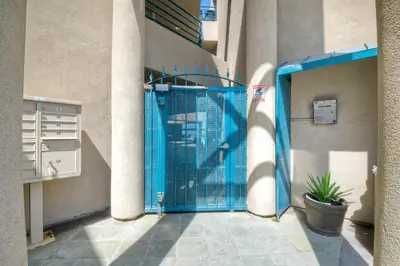 a blue gate in front of a building at 3BR Oceanview, Gated Community & Parking, Elevator in Oceanside