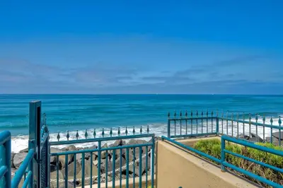a view of the ocean from a gate at the beach at 3BR Oceanview, Gated Community & Parking, Elevator in Oceanside