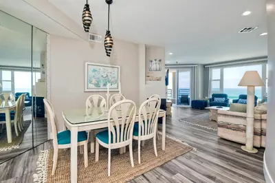 a dining room and living room with a table and chairs at 3BR Oceanview, Gated Community & Parking, Elevator in Oceanside