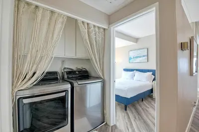 a small kitchen with a stove and a bed at 3BR Oceanview, Gated Community & Parking, Elevator in Oceanside