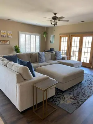 a living room with two couches and a table at Acres of Bliss - A hillside getaway in Ramona