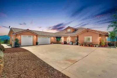 a large house with a large driveway at Acres of Bliss - A hillside getaway in Ramona