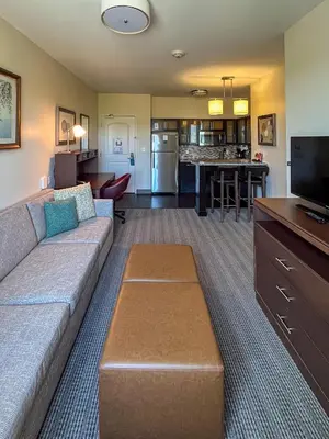 a living room with a couch and a kitchen at Staybridge Suites Carlsbad/San Diego by IHG in Carlsbad