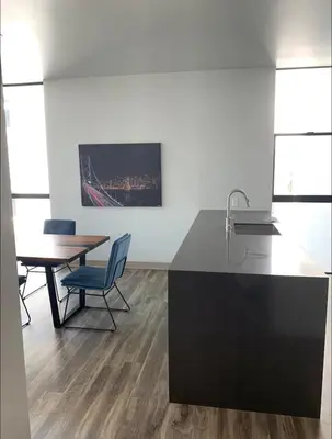 a kitchen and dining room with a table and chairs at Modern 2-Bedroom Apartment in Little Italy in San Diego