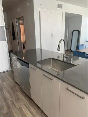 a kitchen with a sink and a counter top at Modern 2-Bedroom Apartment in Little Italy in San Diego