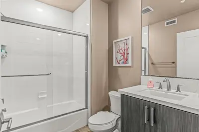 a bathroom with a shower and a toilet and a sink at Oceanside Escape 700S-102 in Oceanside