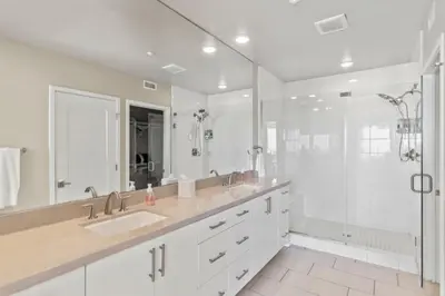 a white bathroom with two sinks and a shower at Oceanside Oasis 700S-103 in Oceanside