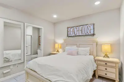 a bedroom with a large bed and a mirror at Oceanside Oasis 700S-103 in Oceanside