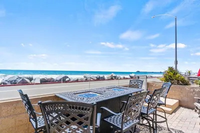 a patio with a table and chairs and the ocean at Oceanside Oasis 700S-103 in Oceanside