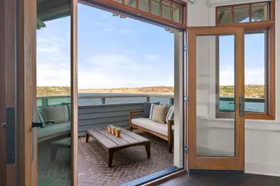 a balcony with a table and a couch on a boat at La Jolla Cove-Oceanfront 5600SF 3BR+Loft 5BA House best Villiage location walk everywhere in San Diego