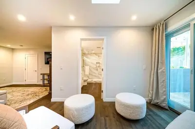 a living room with two white stools at Panoramic Ocean Vistas With Hot Tub and Firepit in San Diego