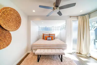 a bedroom with a bed and a ceiling fan at Panoramic Ocean Vistas With Hot Tub and Firepit in San Diego