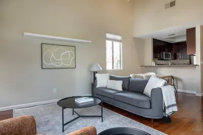 a living room with a couch and a table at Blueground Mission Valley w gym pool SAN-43 in San Diego