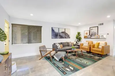 a living room with two couches and a table at Bohemia Casa Family and Pet friendly. 3mi to the beach in San Juan Capistrano