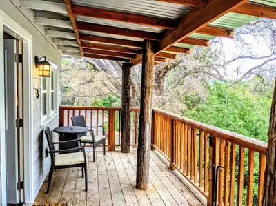 a wooden porch with a table and chairs on it at #3 Howling Wolf's Lair - Cabin W/Fireplace & Views in Santa Ysabel