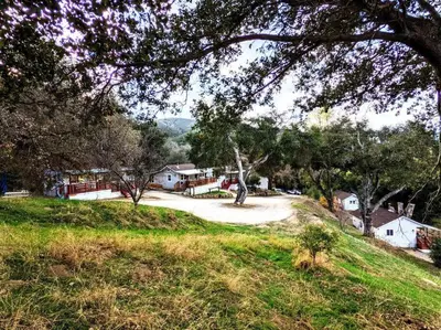 a house on a hill with a driveway at #7 Josie's Mountain Top Hideout-Cabin in the Woods in Santa Ysabel