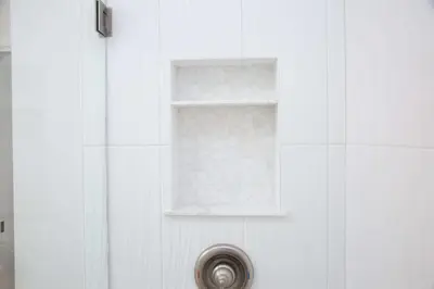 a shower with a window on a white tile wall at Boho Solana Stunner in Solana Beach