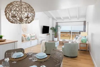 a dining room and living room with a table and chairs at Boho Solana Stunner in Solana Beach