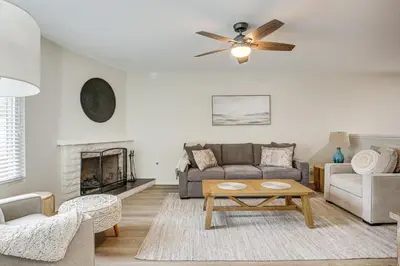 a living room with a couch and a fireplace at Sunny Oceanside Home with Patio, 5 Mi to Downtown! in Oceanside