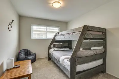 a bedroom with a bunk bed and a desk at Sunny Oceanside Home with Patio, 5 Mi to Downtown! in Oceanside