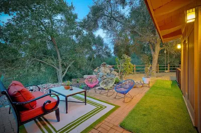 a patio with a group of chairs and a table at City Getaway, Hot Tub, Fire Pit, Game Room, BBQ, Hiking Trails, Vineyard Views, B-Ball in Fallbrook