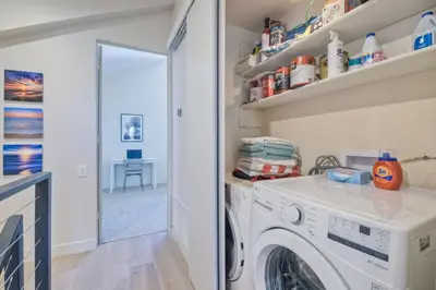 a laundry room with a washer and dryer at Oceanfront, Luxury Remodel, Pool, Walk To Dining in Encinitas