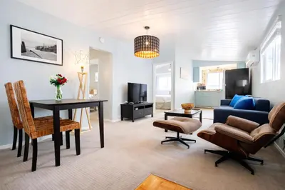 a living room with a blue couch and a table at Idyllic 1BR APT in Ocean Beach in San Diego