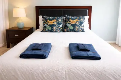 a bed with two blue towels on top of it at Idyllic 1BR APT in Ocean Beach in San Diego