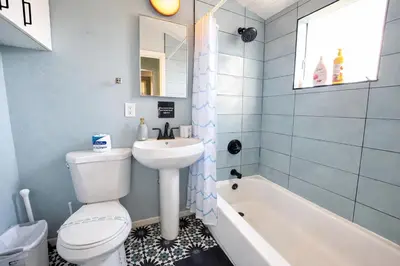 a bathroom with a toilet and a sink and a tub at Idyllic 1BR APT in Ocean Beach in San Diego