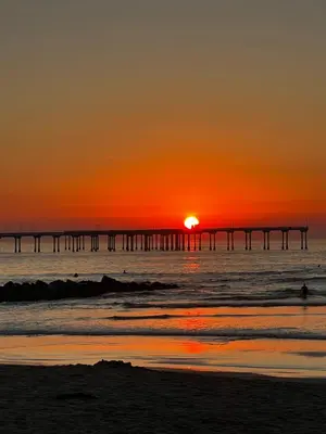 a sunset over the ocean with a pier at Idyllic 1BR APT in Ocean Beach in San Diego
