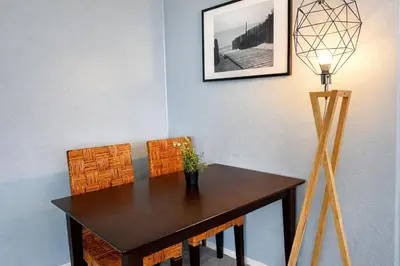 a dining room table with chairs and a lamp at Idyllic 1BR APT in Ocean Beach in San Diego