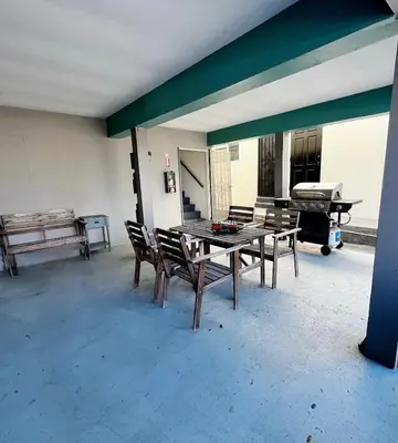 a patio with a table and chairs and a piano at Sunset Haven: Lakeside Charm in Ocean Beach in San Diego
