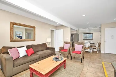 a living room with a couch and a table at Three Bedroom Three Bath Home w Patio 1 block from beach in Newport Beach