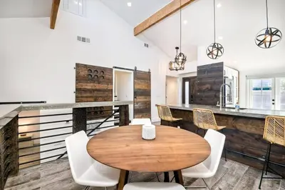 a kitchen with a wooden table and white chairs at Sea Bluff Beach Home in Encinitas