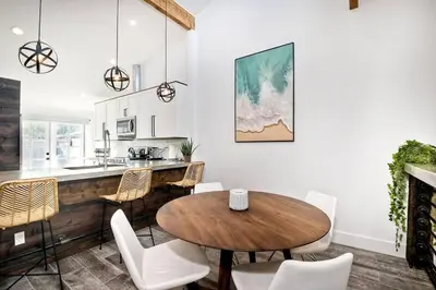 a kitchen and dining room with a wooden table and chairs at Sea Bluff Beach Home in Encinitas