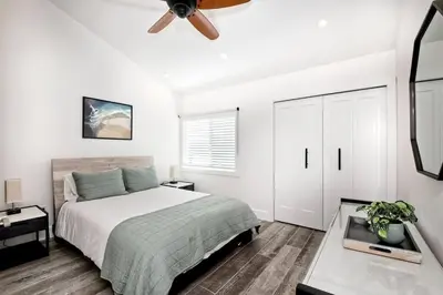a bedroom with a bed and a ceiling fan at Sea Bluff Beach Home in Encinitas