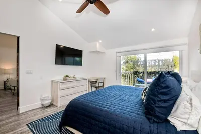 a bedroom with a blue bed and a desk at Sea Bluff Beach Home in Encinitas