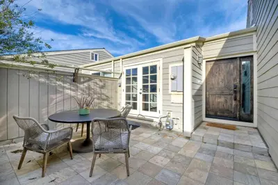 a patio with a table and chairs and a building at Sea Bluff Beach Home in Encinitas