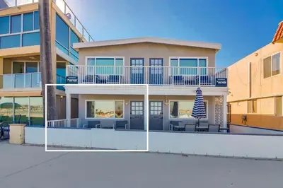 a large house with a balcony with tables and chairs at Bayside 1 in San Diego