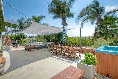 a patio with a table and chairs and a pool at Nice home, Ocean views, and open space views. in Oceanside