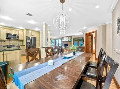 a dining room and kitchen with a large wooden table at Ocean-View Mountaintop Getaway. Jacuzzi/Ping-Pong! in San Diego