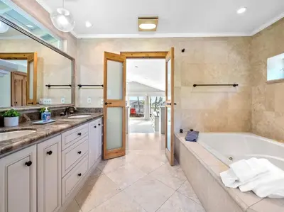 a large bathroom with a tub and a sink at Ocean-View Mountaintop Getaway. Jacuzzi/Ping-Pong! in San Diego