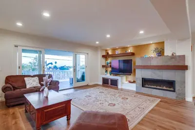 a living room with a couch and a fireplace at Point Loma Serenity in San Diego