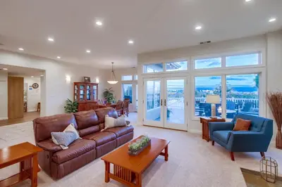 a living room with a brown leather couch and chairs at Point Loma Serenity in San Diego