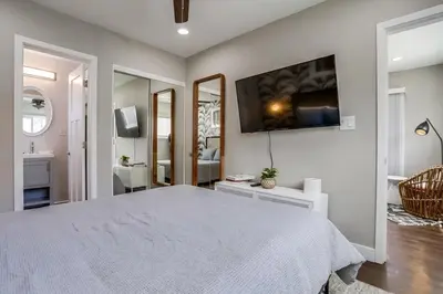 a bedroom with a large bed and a bathroom at Bayside Bikini 2 in San Diego