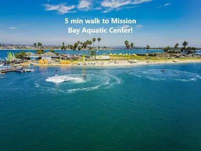 an image of a beach with the words min walk to mission bay aquatic center at Bayside Bikini 2 in San Diego
